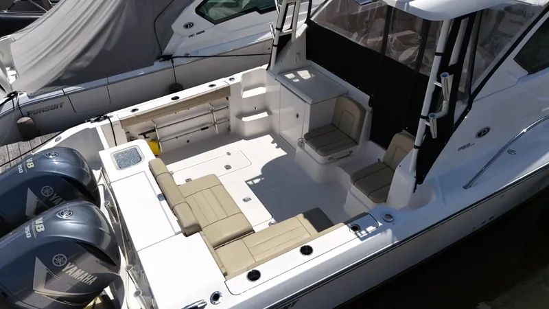 Slide: The Image of 2017 Pursuit OS 355 Offshore boat with Yamaha engines, spacious deck, and seating area. - 10