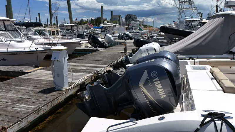Slide: The Image of 2017 Pursuit OS 355 Offshore boat docked with Yamaha outboard motors. - 12