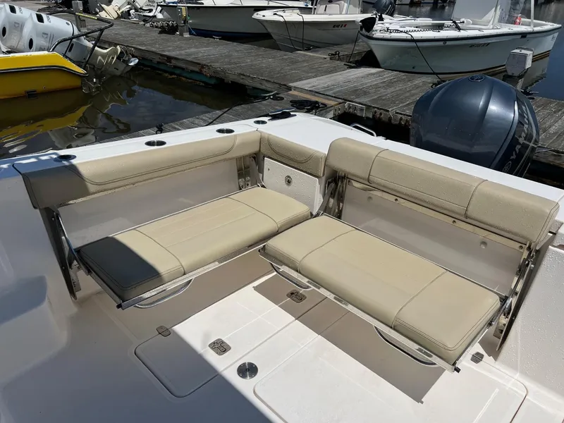 Slide: The Image of 2017 Pursuit OS 355 Offshore boat with beige seating at the dock. - 13