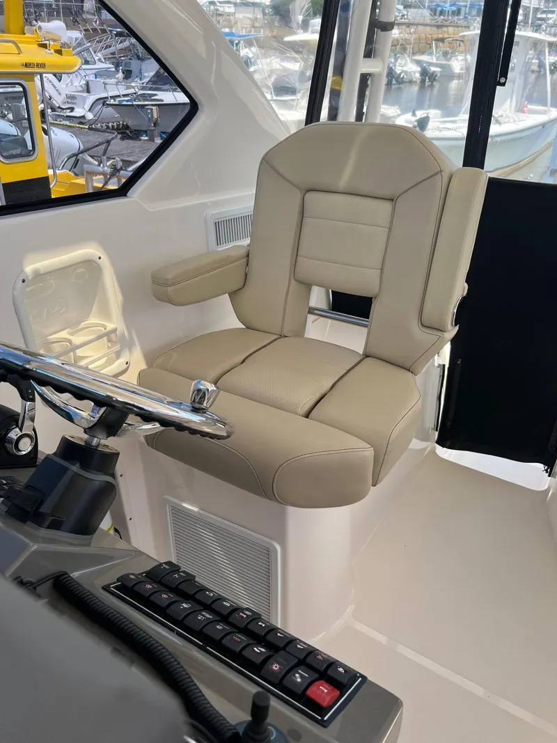 Slide: The Image of Captain's chair on a 2017 Pursuit OS 355 Offshore boat. - 17