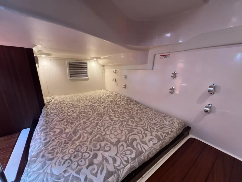Slide: The Image of 2017 Pursuit OS 355 Offshore cabin bed with floral bedding. - 28
