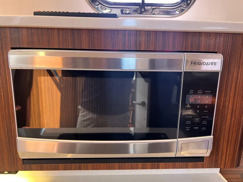 Slide: The Image of Frigidaire microwave in the galley of a 2017 Pursuit OS 355 Offshore boat. - 34