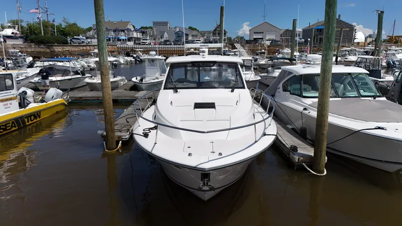 Slide: The Image of 2017 Pursuit OS 355 Offshore boat docked at a marina. - 4