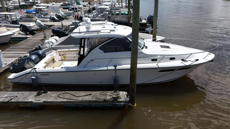 Slide: The Image of 2017 Pursuit OS 355 Offshore boat docked at a marina. - 5