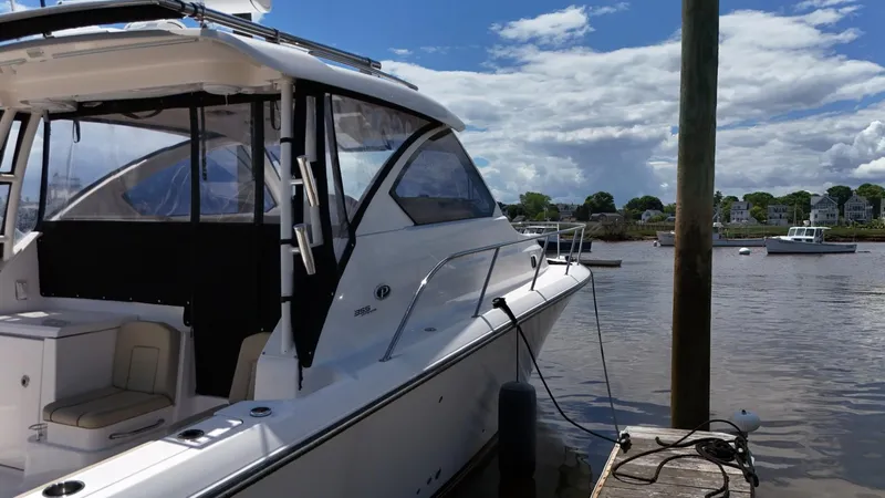 Slide: The Image of 2017 Pursuit OS 355 Offshore boat docked at a marina on a sunny day. - 8