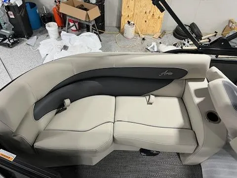 Slide: The Image of 2024 Barletta ARIA 20QC boat interior seating with beige and black upholstery. - 12