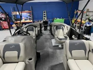 Slide: The Image of 2024 Barletta ARIA 20QC pontoon boat interior with beige and gray seating. - 6