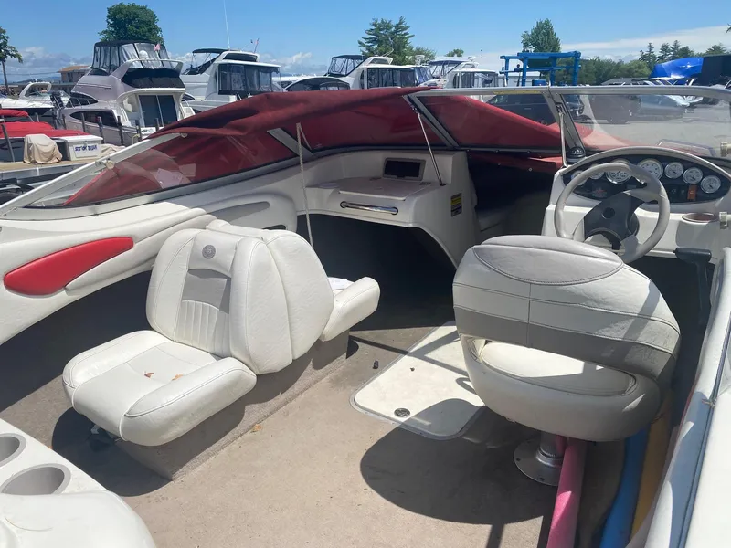 Slide: The Image of 2005 Stingray 195 LS/LX boat interior with white seats and red canopy. - 4