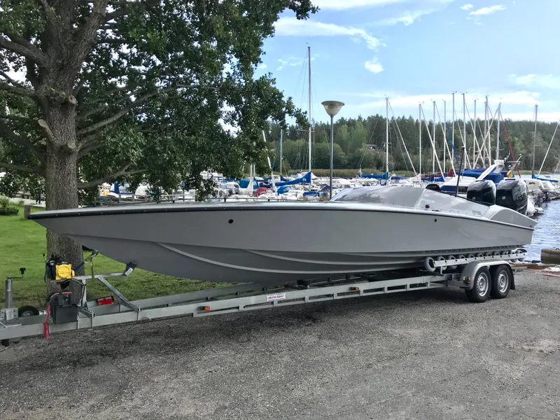 Slide: The Image of 2018 Nitra Boats 29 on a trailer at a marina with sailboats in the background. - 3