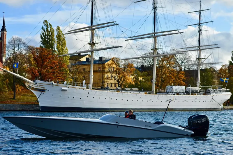 Slide: The Image of 2018 Nitra Boats 29 on water with historic ship and autumn trees in background. - 5