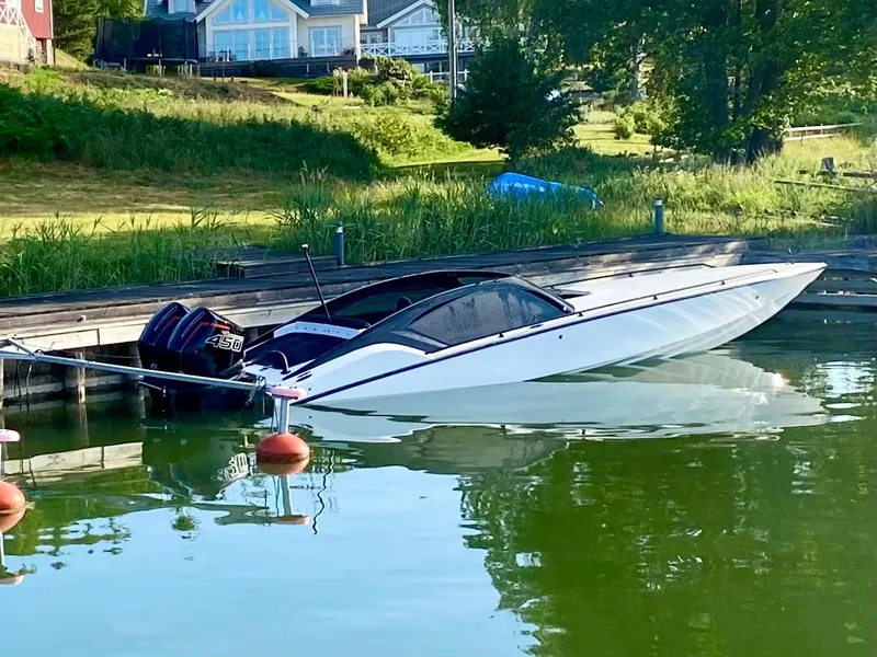 Slide: The Image of 2022 Nitra Boats 30 SkyTop docked on a serene lake with lush greenery. - 3