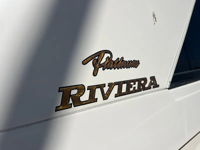 Slide: The Image of Riviera 43 Open Flybridge 1997 emblem on white surface. - 4