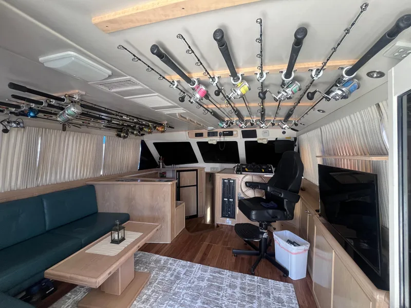 Slide: The Image of Interior of a 1997 Riviera 43 Open Flybridge with fishing rods. - 41