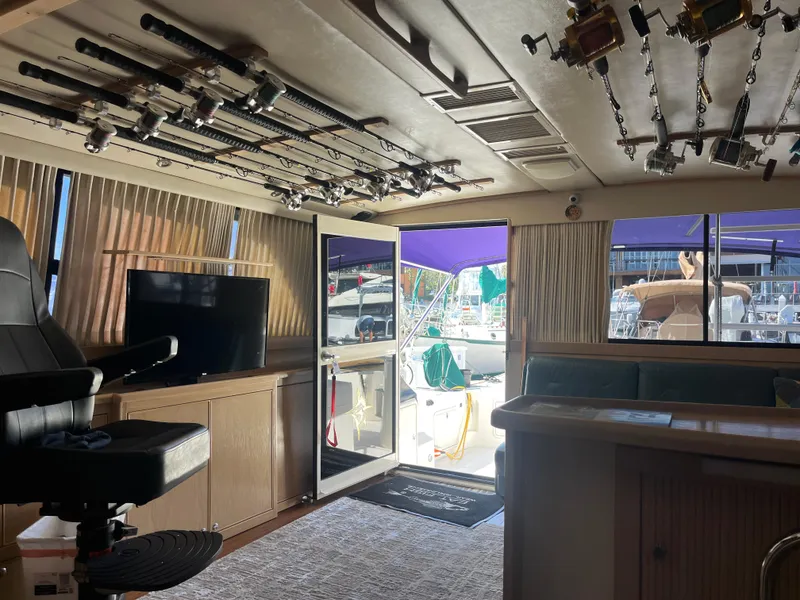 Slide: The Image of Interior of a 1997 Riviera 43 Open Flybridge yacht with fishing rods. - 44