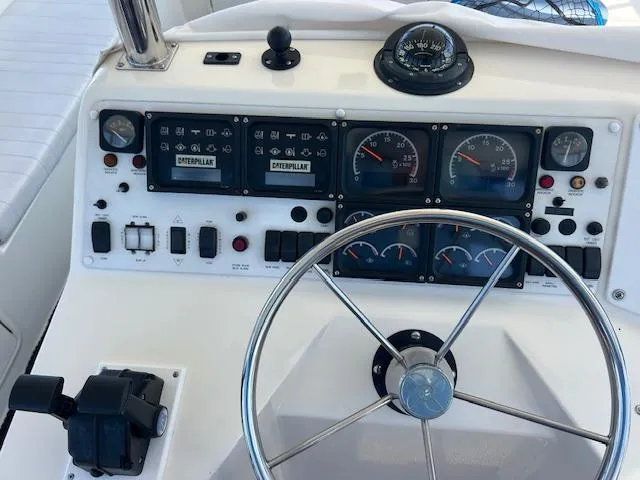 Slide: The Image of 1997 Riviera 43 Open Flybridge helm with gauges and controls. - 6