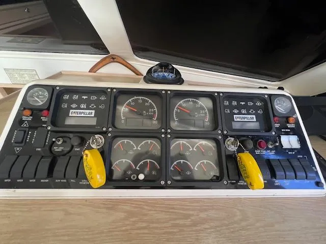 Slide: The Image of Control panel of a 1997 Riviera 43 Open Flybridge boat with Caterpillar engine gauges. - 7