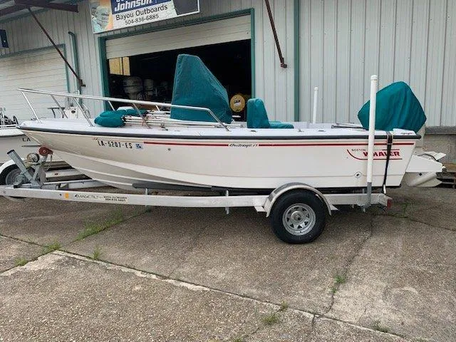 Slide: The Image of 1996 Boston Whaler 17 Outrage II on trailer outside a workshop. - 3