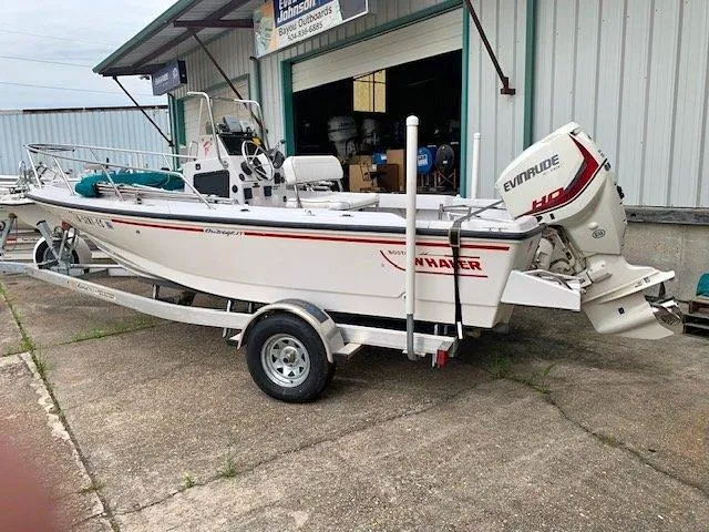 Slide: The Image of 1996 Boston Whaler 17 Outrage II boat on trailer with Evinrude outboard motor. - 5