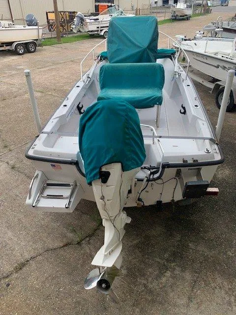 Slide: The Image of 1996 Boston Whaler 17 Outrage II boat with covered outboard motor and seats. - 6