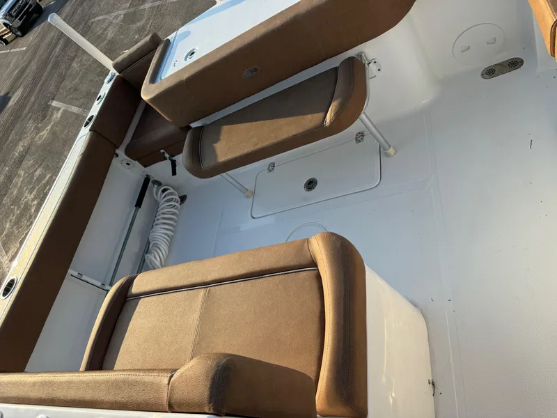 Slide: The Image of 2024 Sea Hunt Gamefish 30 Forward Seating, brown cushioned seats, white deck. - 10