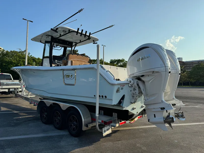 Slide: The Image of 2024 Sea Hunt Gamefish 30 Forward Seating boat on a trailer with twin Yamaha engines. - 4