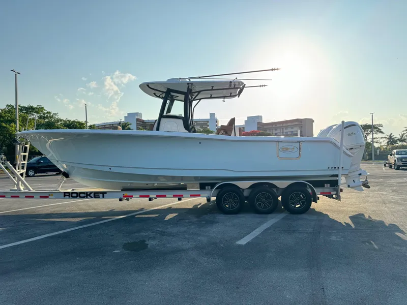 Slide: The Image of 2024 Sea Hunt Gamefish 30 Forward Seating boat on a trailer in a parking lot. - 5