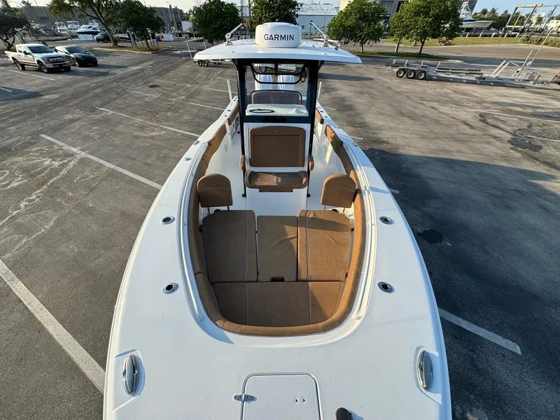 Slide: The Image of 2024 Sea Hunt Gamefish 30 Forward Seating boat with Garmin electronics, docked in a parking lot. - 7