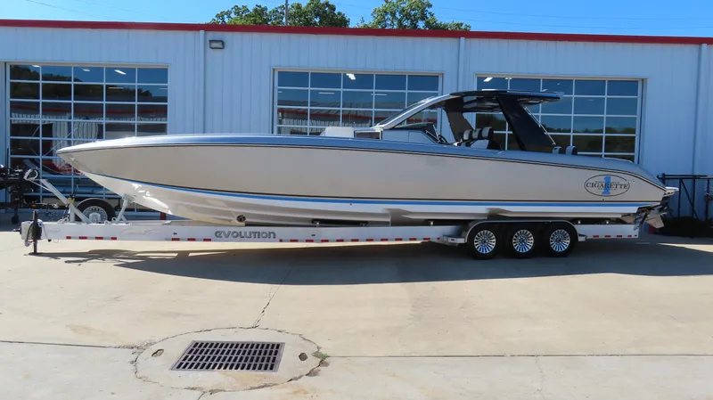 The Image of 2024 Cigarette 41 Nighthawk SD Edition boat on a trailer outside a garage. - 0