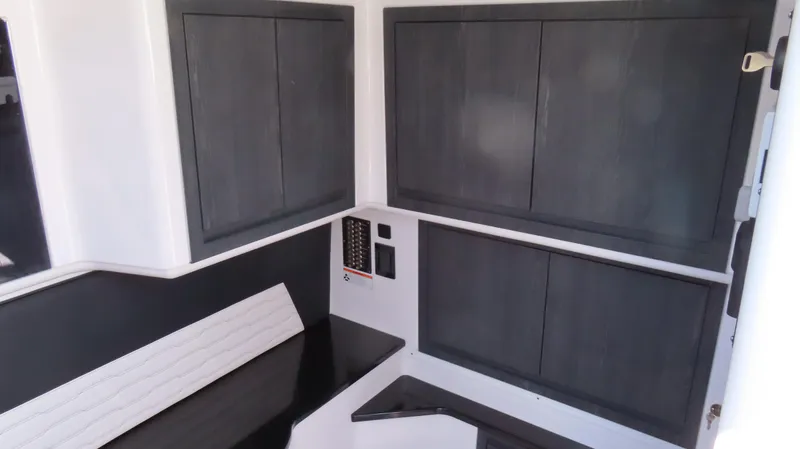 Slide: The Image of 2024 Cigarette 41 Nighthawk SD Edition interior with sleek black cabinetry and modern design. - 19