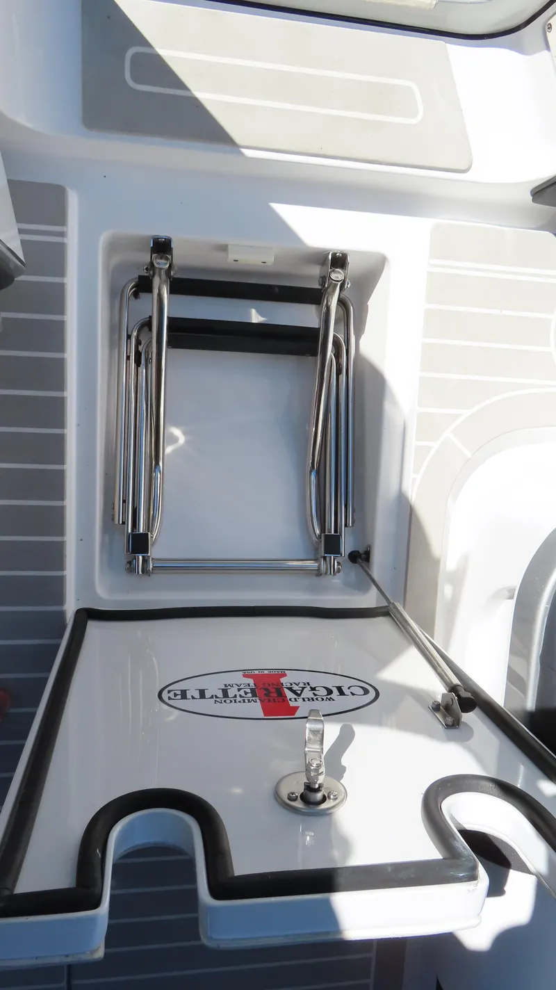 Slide: The Image of 2024 Cigarette 41 Nighthawk SD Edition boat ladder and storage compartment. - 24