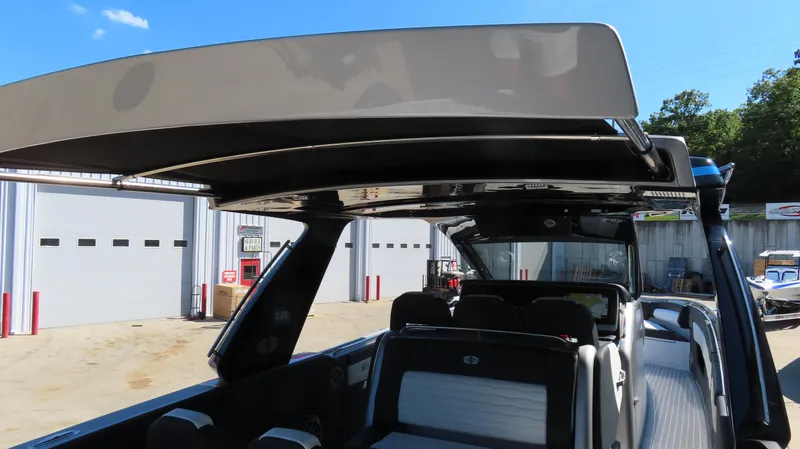 Slide: The Image of 2024 Cigarette 41 Nighthawk SD Edition boat with open canopy in a marina. - 25