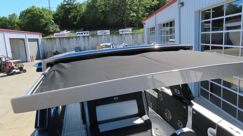 Slide: The Image of 2024 Cigarette 41 Nighthawk SD Edition boat with black canopy in a marina. - 26