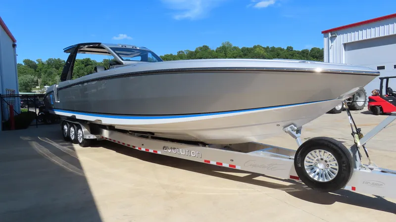 Slide: The Image of 2024 Cigarette 41 Nighthawk SD Edition boat on a trailer in a marina. - 3