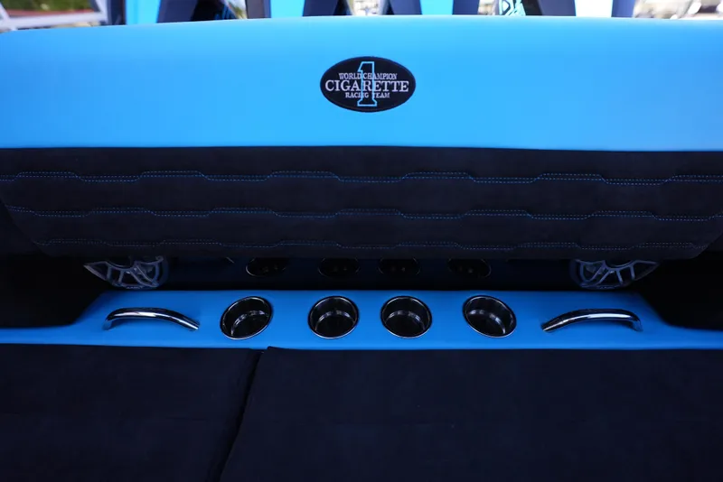 Slide: The Image of 2025 Cigarette 41 Nighthawk boat interior with blue and black seating and cup holders. - 11