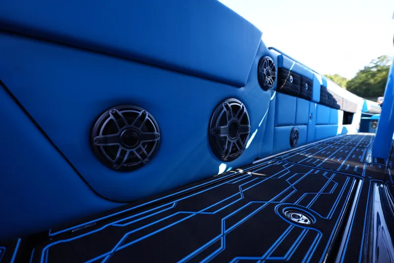 Slide: The Image of 2025 Cigarette 41 Nighthawk boat interior with blue upholstery and built-in speakers. - 13