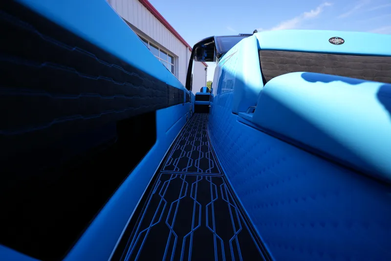 Slide: The Image of 2025 Cigarette 41 Nighthawk boat, close-up of sleek blue design and deck. - 25