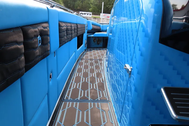 Slide: The Image of 2025 Cigarette 41 Nighthawk interior with blue upholstery and patterned flooring. - 54