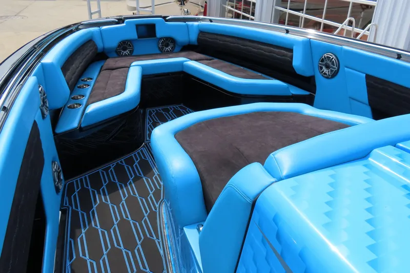 Slide: The Image of 2025 Cigarette 41 Nighthawk boat interior with blue and black seating and speakers. - 55