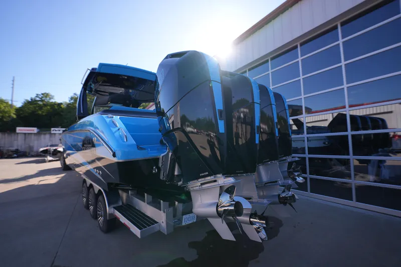 Slide: The Image of 2025 Cigarette 41 Nighthawk boat with triple outboard engines in a marina. - 6