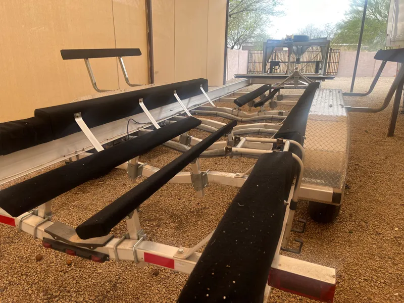 Slide: The Image of 2020 Kokopelli trailer with padded supports, parked on gravel under a canopy. - 5