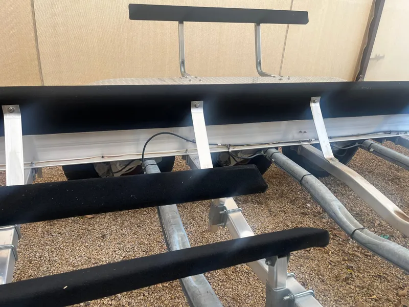 Slide: The Image of 2020 Kokopelli Trailer with padded supports on gravel surface. - 6