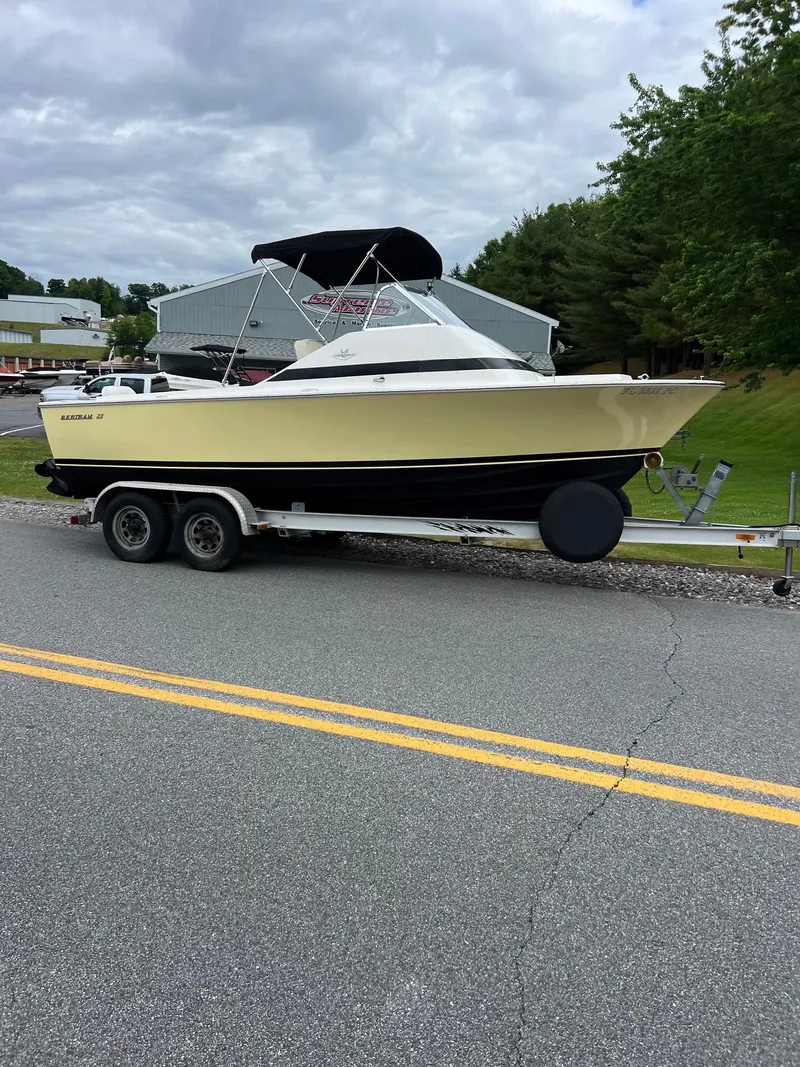 Slide: The Image of 1969 Bertram Bahia Mar 20 boat on a trailer, parked on a road. - 12