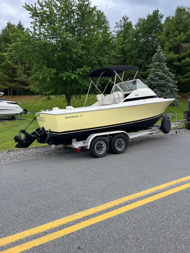 Slide: The Image of 1969 Bertram Bahia Mar 20 boat on a trailer, parked on a roadside. - 13