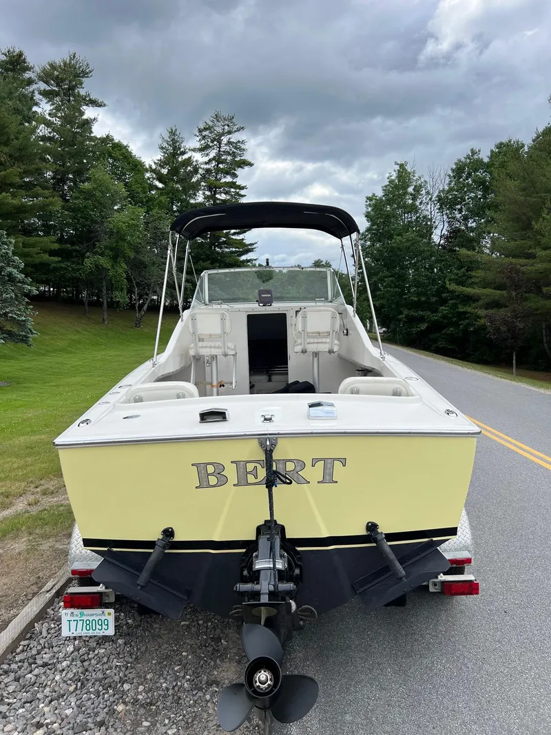 Slide: The Image of 1969 Bertram Bahia Mar 20 boat on a trailer, parked on a road. - 14