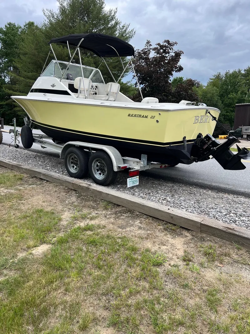 Slide: The Image of 1969 Bertram Bahia Mar 20 boat on a trailer, parked outdoors. - 15