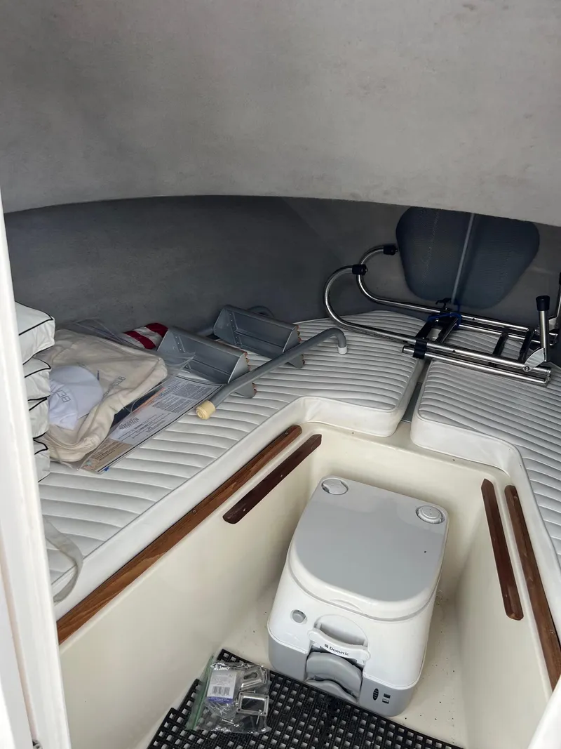 Slide: The Image of 1969 Bertram Bahia Mar 20 cabin interior with seating and portable toilet. - 7