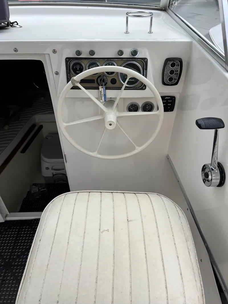 Slide: The Image of 1969 Bertram Bahia Mar 20 boat cockpit with steering wheel and control panel. - 8