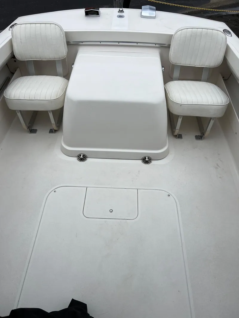 Slide: The Image of 1969 Bertram Bahia Mar 20 boat interior with white seating and storage compartment. - 9