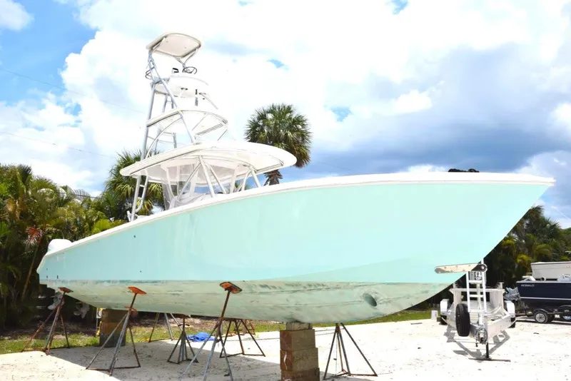 The Image of Light blue 2016 Bahama 2021 Verado 400s boat on stands, palm trees in background. - 0
