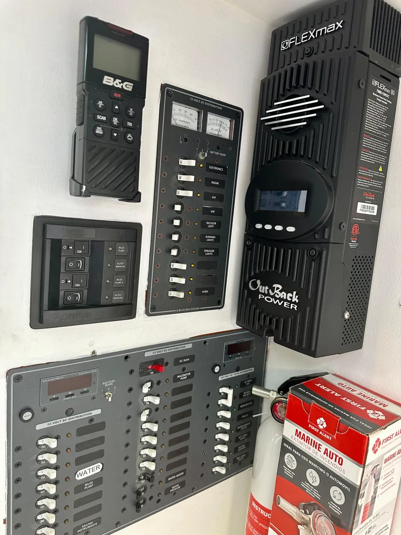 Slide: The Image of Electrical control panel on a 1983 Tayana 55 yacht with various switches and devices. - 10